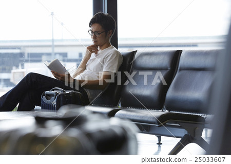 A man waiting for departure at the airport A man waiting for departure at the airport 25033607