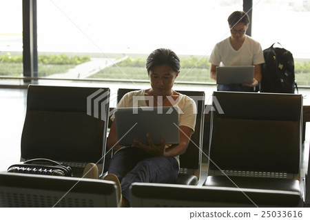 A man waiting for departure at the airport A man waiting for departure at the airport 25033616