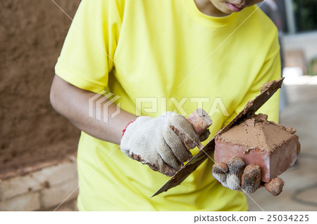 Bricklayer with red concrete bricks Bricklayer with red concrete bricks 25034225