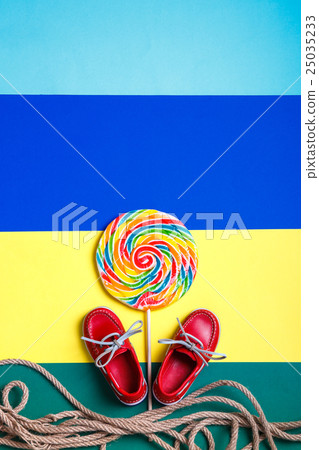 Small red boat shoes near big lollipop Small red boat shoes near big lollipop 25035233