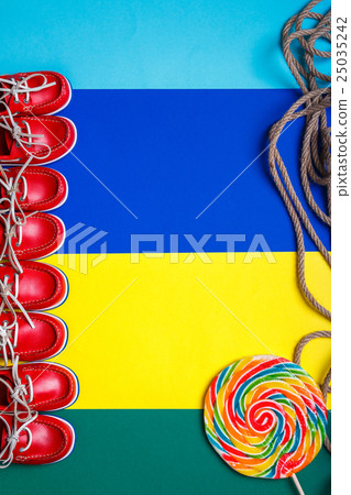 lot of small red boat shoes near big lollipop lot of small red boat shoes near big lollipop 25035242