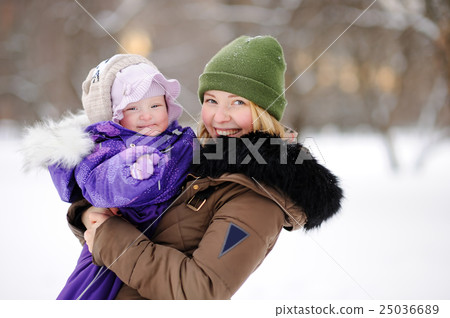 Woman with her toddler daughter at the winter park Woman with her toddler daughter at the winter park 25036689