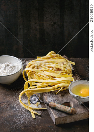 Raw homemade pasta tagliatelle Raw homemade pasta tagliatelle 25036959