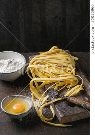 Raw homemade pasta tagliatelle Raw homemade pasta tagliatelle 25036960