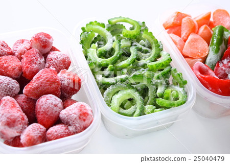 Frozen vegetables in a storage container, frozen strawberries, bitter gourd and carrots 25040479