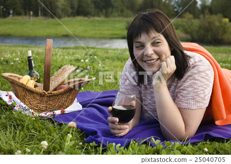 mature brunette happy smiling woman with glass of 25040705