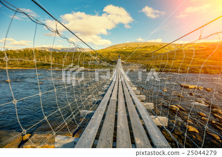 hanging bridge over mountain river 25044279