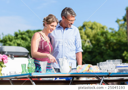Couple buying stuff at flea market Couple buying stuff at flea market 25045193
