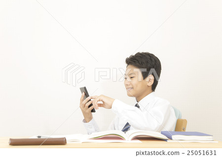 A boy engaged in smartphone than studying A boy engaged in smartphone than studying 25051631