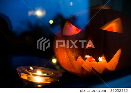 Halloween pupkin symbol behind the home window Halloween pupkin symbol behind the home window 25052283