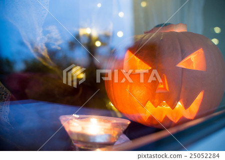 Halloween pupkin symbol behind the window Halloween pupkin symbol behind the window 25052284
