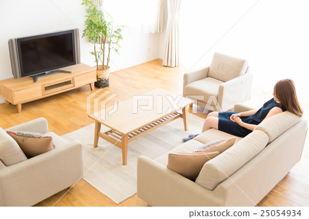 A woman watching TV 25054934