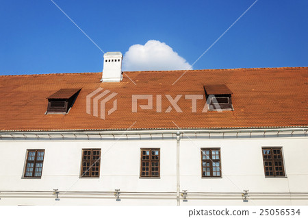 Old tiled roof with two attic windows and chimney Old tiled roof with two attic windows and chimney 25056534
