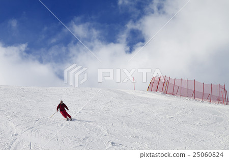 Skier on ski slope at nice sun day 25060824