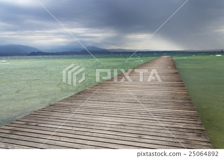 Wooden pier waves Lago di Garda, Sirmione, Italy 25064892