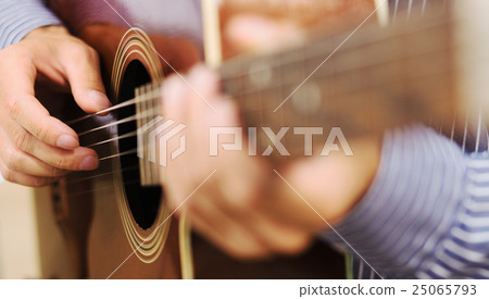 Handsome man playing guitar at home Handsome man playing guitar at home 25065793