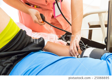 Closeup of nurse taking patient blood pressure Closeup of nurse taking patient blood pressure 25066695