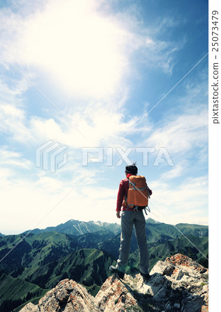 successful woman hiker hiking at mountain peak 25073479