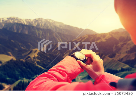 successful woman hiker hiking at mountain peak 25073480