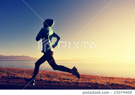 young woman runner running on sunrise seaside  25074409