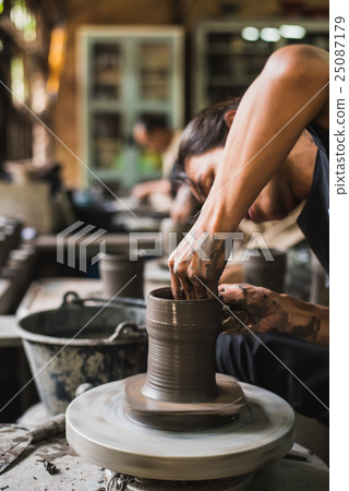 potter's hands shaping soft clay make earthen pot 25087179