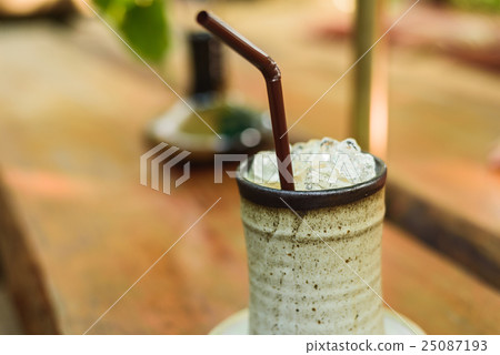 orange cake with ice coffee on wood table 25087193