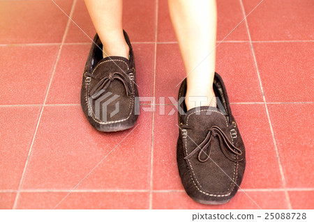 Little boy wearing his father shoes 25088728