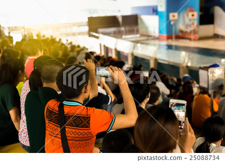 Focus on man taking photo with cell phone 25088734