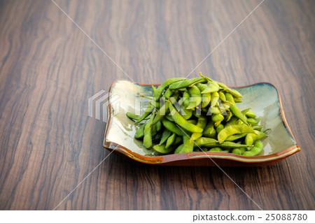 Soybean put in a plate placed on a wooden table Soybean put in a plate placed on a wooden table 25088780