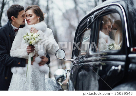 beautiful couple standing near a wedding cortege 25089543