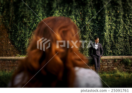 Look from woman's shoulder on a lonely man  25091761