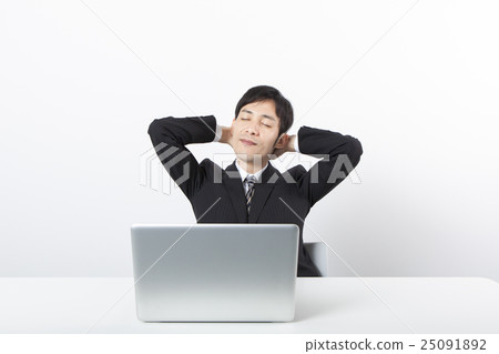 A businessman who falls asleep in front of a personal computer A businessman who falls asleep in front of a personal computer 25091892