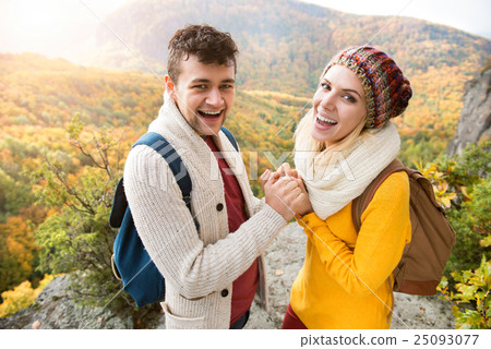 Beautiful couple in autumn nature against colorful 25093077