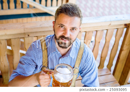 Man in traditional bavarian clothes with beer and Man in traditional bavarian clothes with beer and 25093095
