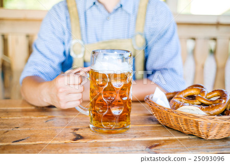 Man in traditional bavarian clothes with beer and 25093096