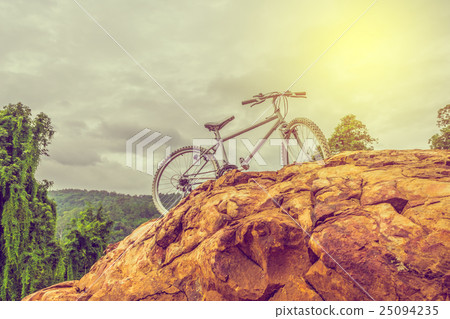 bicycle on the top of rock mountain 25094235
