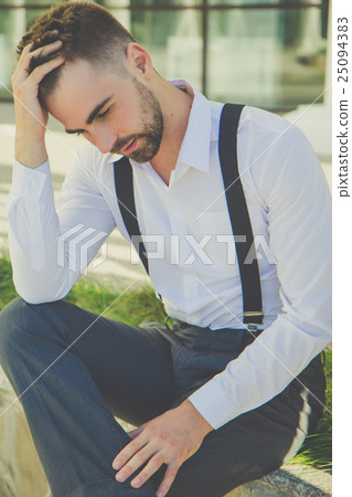Portrait of man with beard is wearing suspenders 25094383