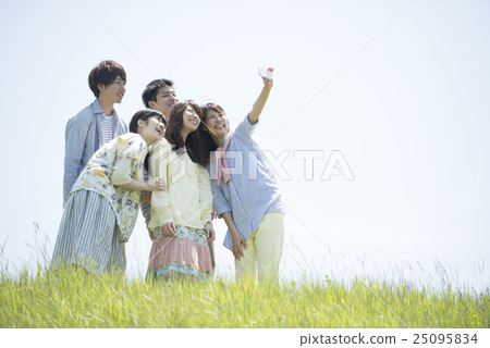 College students taking pictures of themselves in the field College students taking pictures of themselves in the field 25095834