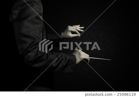 Orchestra conductor hands, Musician director holding stick on dark background 25096119
