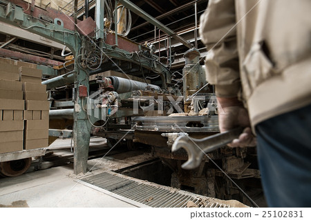 Image of worker in workshop for bricks production 25102831