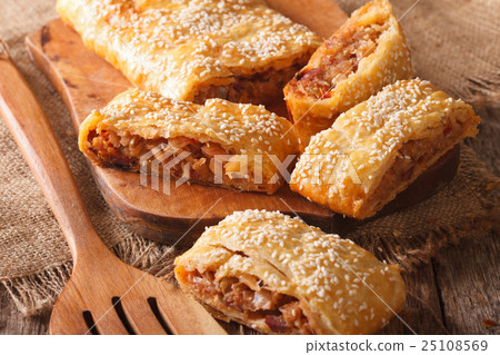 Tasty puff pie stuffed with cabbage and sausages Tasty puff pie stuffed with cabbage and sausages 25108569