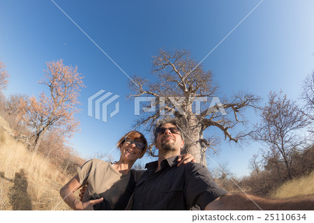 Couple taking selfie near Baobab plant 25110634