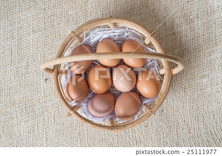 Eggs in bamboo basket on jute sack 25111977