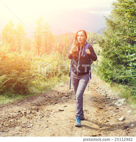 Young backpacker woman enjoying mountain trip 25112982