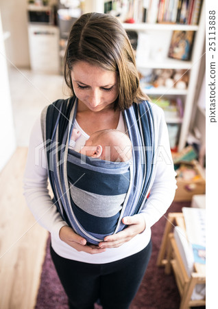 Beautiful young mother with her son in sling Beautiful young mother with her son in sling 25113888