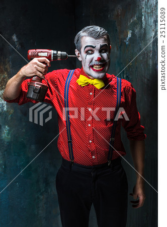 The scary clown and electric drill on dack 25115089