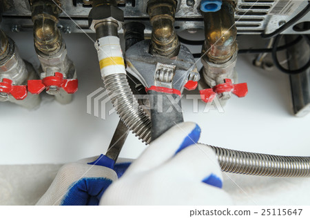 Plumber attaching to pipe gas boiler. Plumber attaching to pipe gas boiler. 25115647