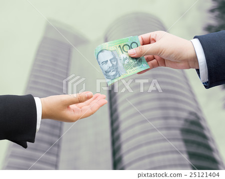 Hands of businessman passing AUD banknote. Hands of businessman passing AUD banknote. 25121404