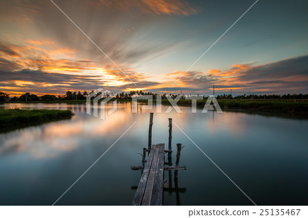 Wood bridge in the port at sunset. 25135467