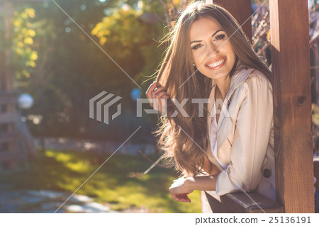 Portrait of smiling young woman, autumn time 25136191